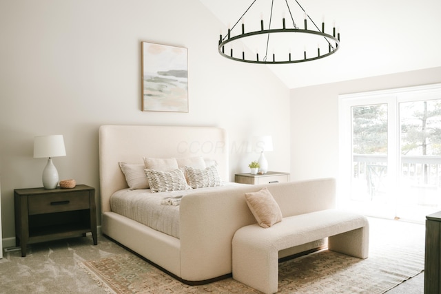 bedroom featuring lofted ceiling, carpet flooring, and a notable chandelier