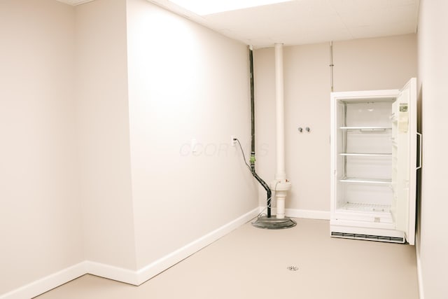 interior space with concrete floors and baseboards