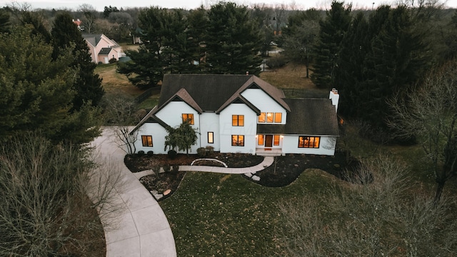 view of front of home with a front lawn and a chimney