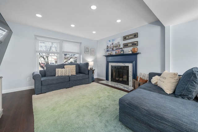 living area featuring dark wood-style floors, a fireplace, baseboards, and recessed lighting