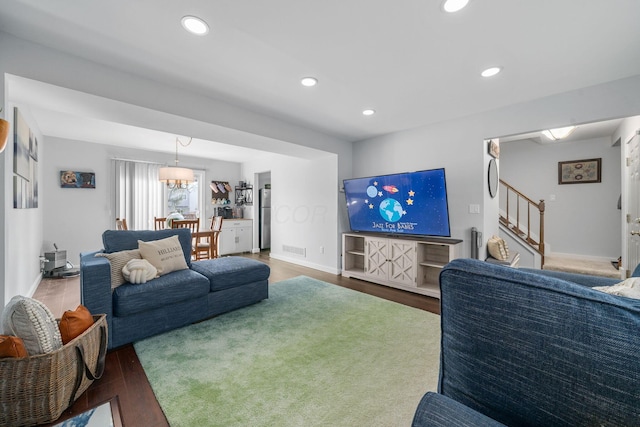 living area featuring recessed lighting, visible vents, stairway, wood finished floors, and baseboards