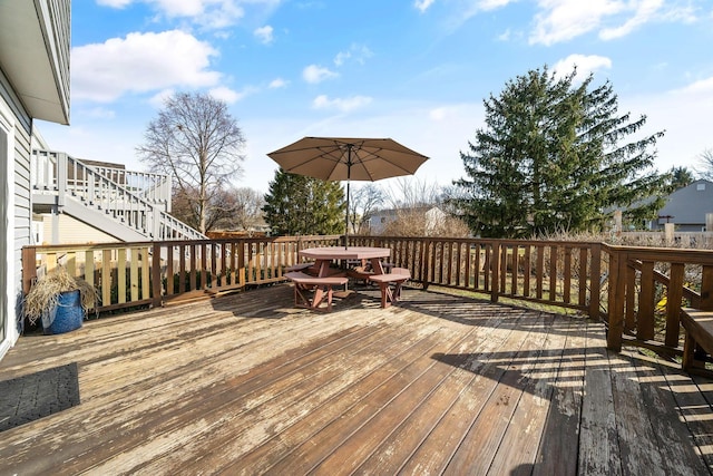 wooden deck with stairs and outdoor dining space