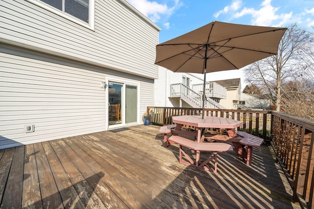 wooden terrace with outdoor dining space