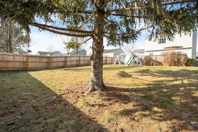 view of yard featuring a playground and a fenced backyard