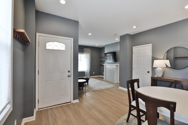 foyer with recessed lighting, light wood-type flooring, and baseboards