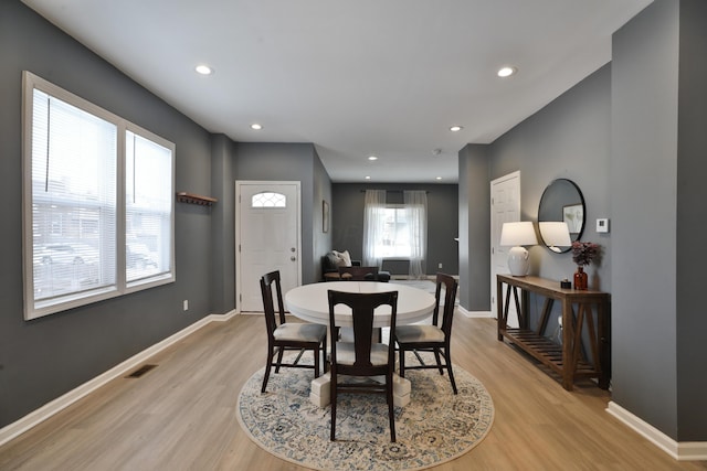 dining room with light wood-type flooring, baseboards, visible vents, and recessed lighting