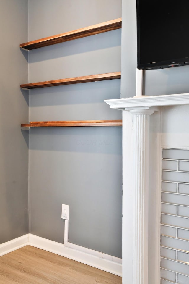 interior details featuring baseboards and wood finished floors