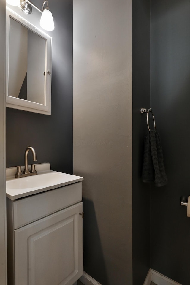 bathroom featuring baseboards and vanity