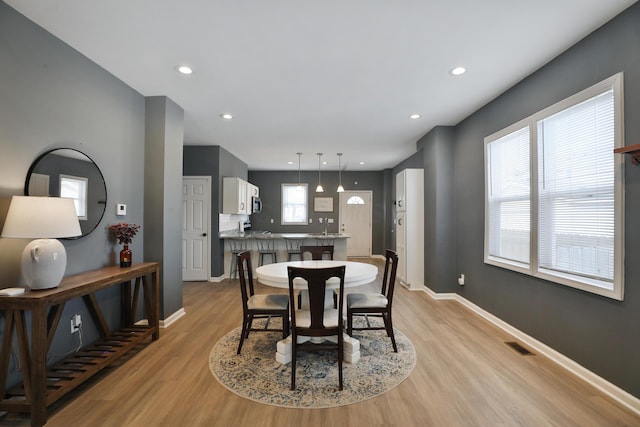 dining room featuring recessed lighting, visible vents, light wood-style flooring, and baseboards