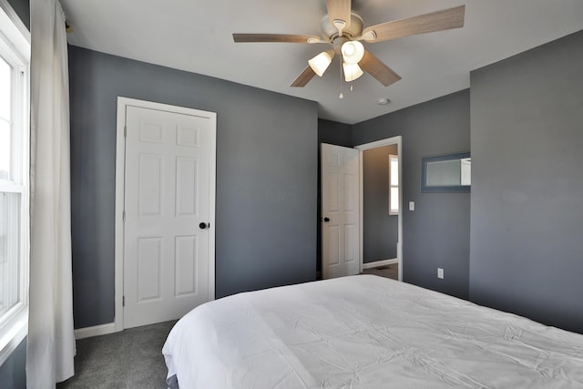 bedroom with carpet floors, ceiling fan, and baseboards