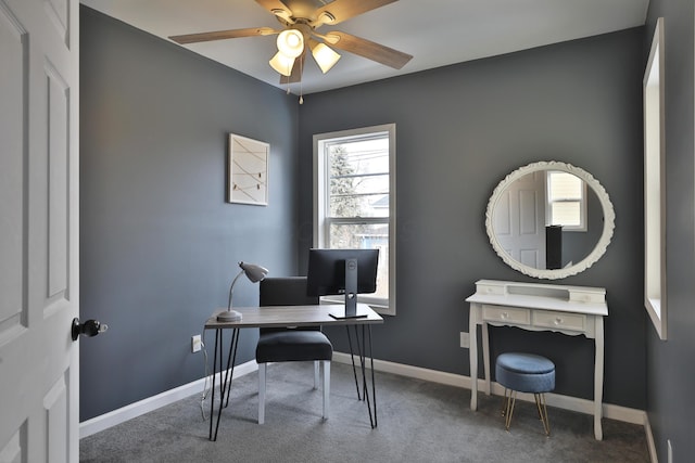 office area with carpet, baseboards, and a ceiling fan