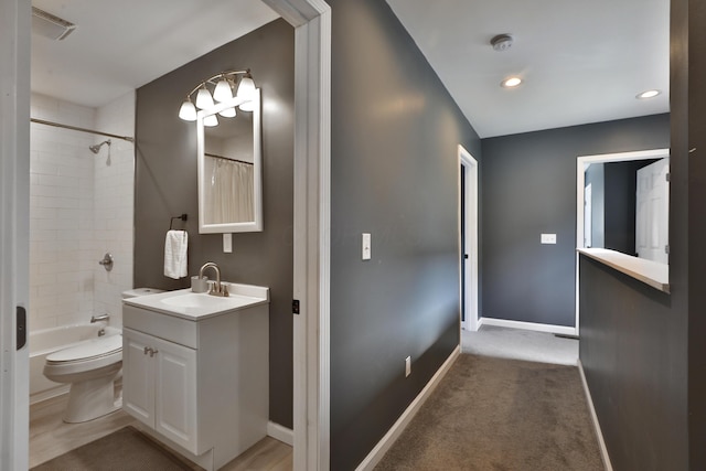 bathroom featuring toilet, shower / bath combination with curtain, vanity, and baseboards