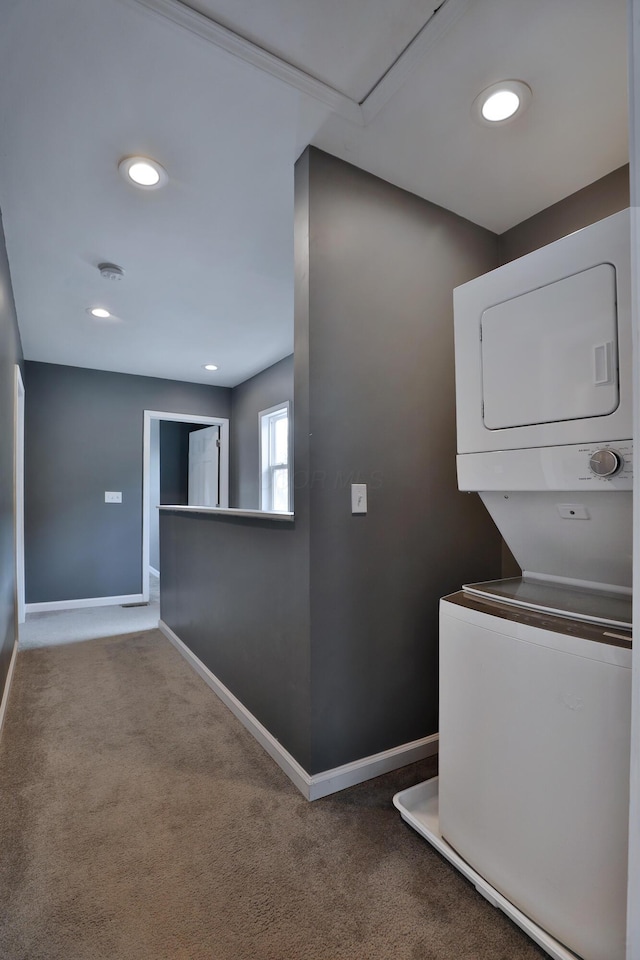 corridor with baseboards, recessed lighting, carpet, and stacked washer / drying machine