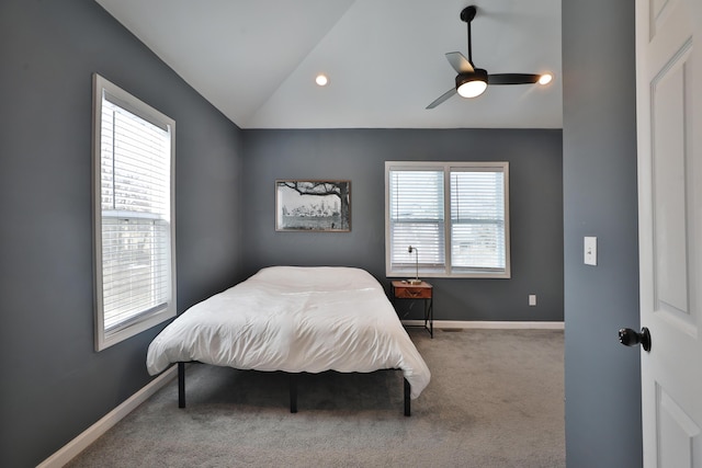 carpeted bedroom featuring a ceiling fan, vaulted ceiling, and baseboards