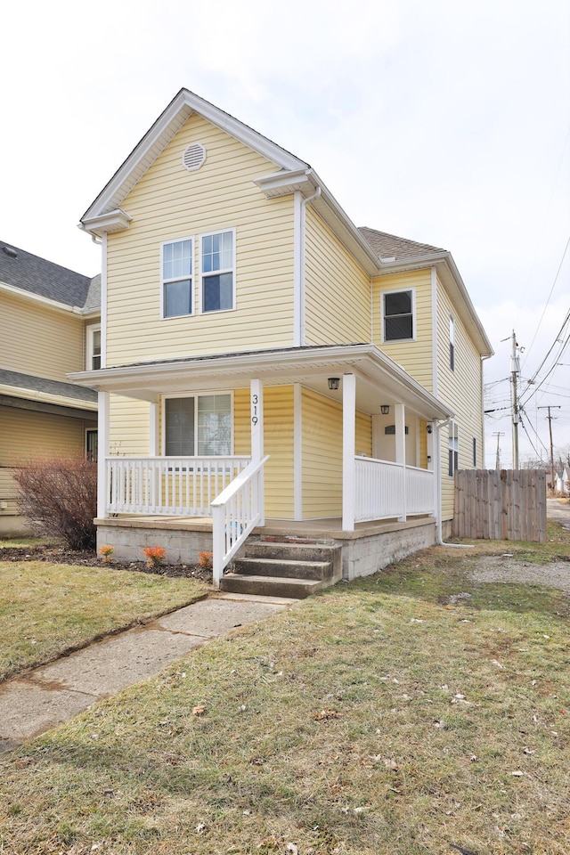 view of front of home with covered porch and a front yard