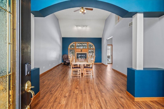 dining room with baseboards, ceiling fan, visible vents, and wood finished floors