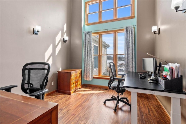 office area with light wood-style flooring and baseboards