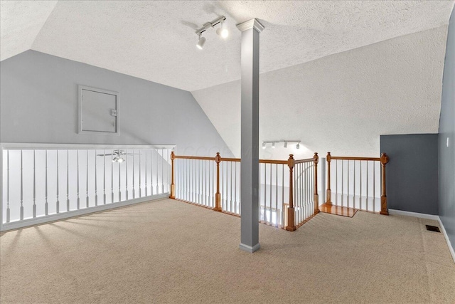 bonus room featuring carpet flooring, vaulted ceiling, visible vents, and a textured ceiling