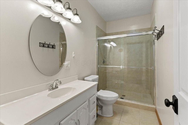 full bath with a stall shower, toilet, tile patterned flooring, a textured ceiling, and vanity