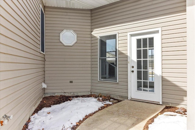 view of snow covered property entrance