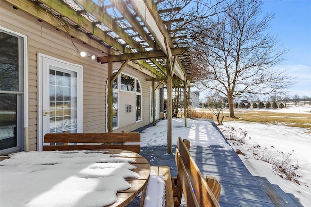 snow covered deck with a pergola