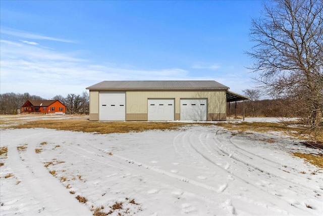 snow covered garage with a garage