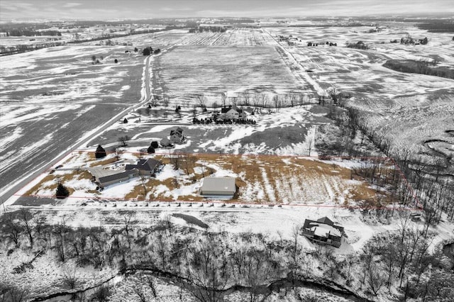 snowy aerial view featuring a rural view