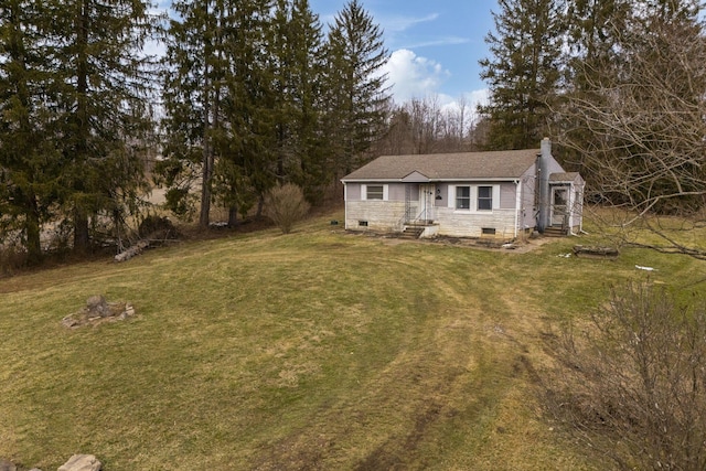 view of front of home with a front lawn, crawl space, and a chimney