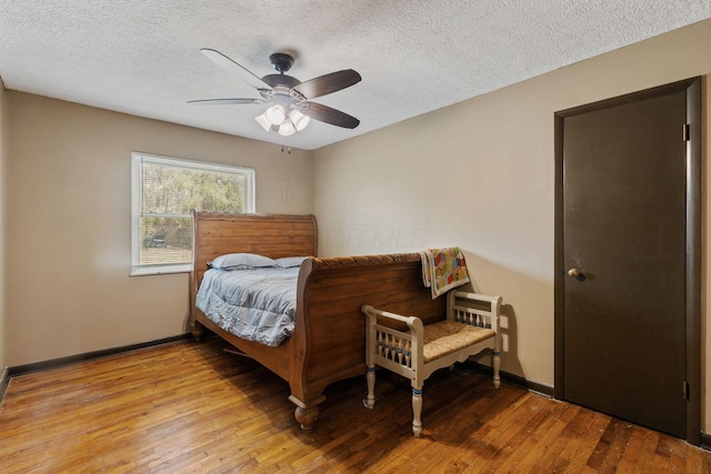 bedroom with light wood-type flooring, ceiling fan, and baseboards