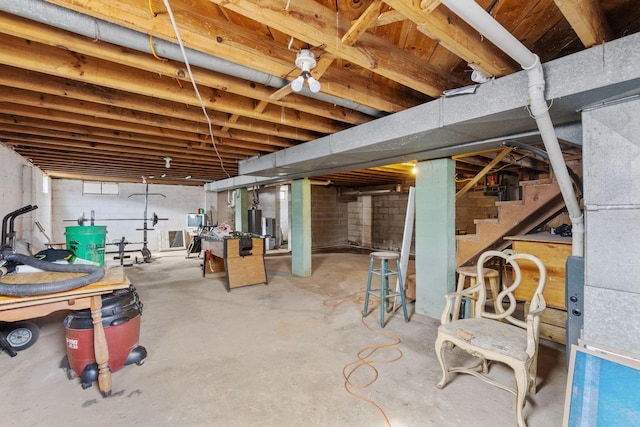 unfinished basement featuring stairs