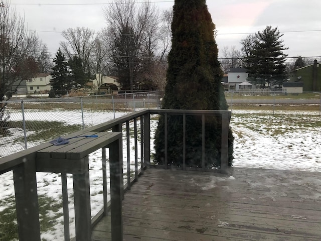 snow covered deck with fence