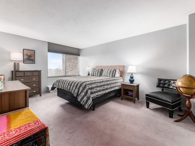 bedroom with a textured ceiling and carpet