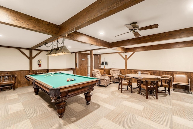 game room with light colored carpet, beam ceiling, and wainscoting