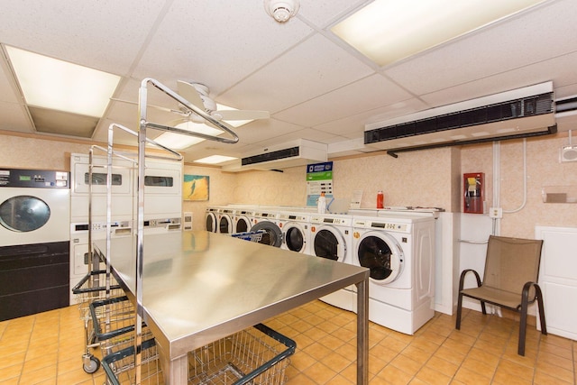 shared laundry area featuring independent washer and dryer, light tile patterned flooring, a ceiling fan, and stacked washer and clothes dryer