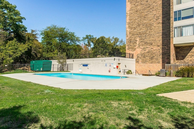 pool with a yard, a patio area, and fence