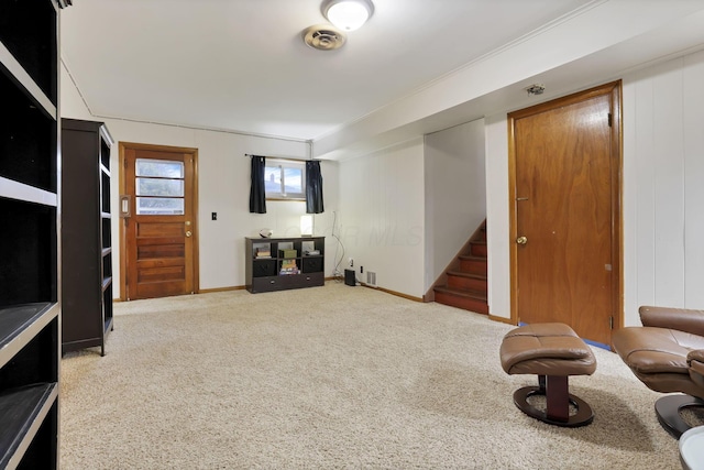 carpeted living area with visible vents, stairs, and baseboards