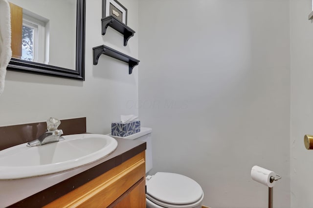 bathroom with toilet and vanity