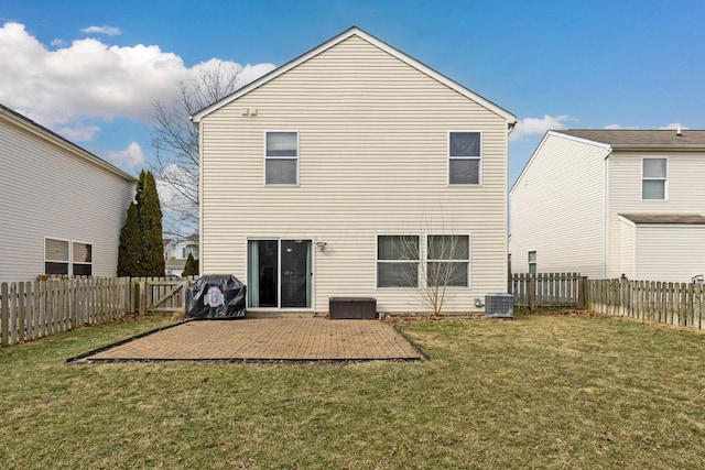 rear view of property with a yard, a patio area, a fenced backyard, and central air condition unit