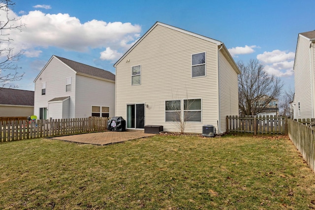 rear view of house with a yard, central AC unit, a patio area, and a fenced backyard