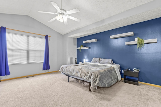 bedroom with carpet flooring, vaulted ceiling, a textured ceiling, and baseboards