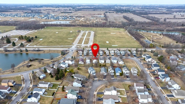 birds eye view of property with a water view and a residential view