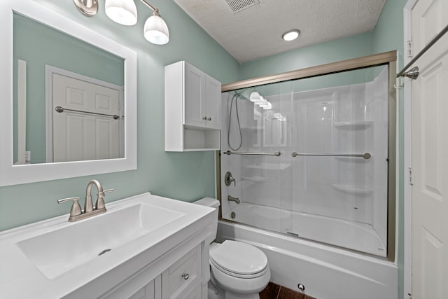 full bathroom with visible vents, toilet, combined bath / shower with glass door, a textured ceiling, and vanity