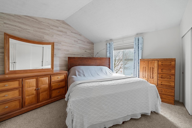 bedroom featuring light carpet and vaulted ceiling