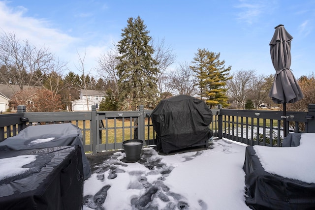 snow covered deck featuring a grill