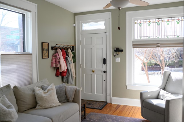 foyer entrance featuring ceiling fan, wood finished floors, and baseboards