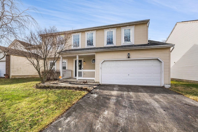 traditional home with an attached garage, covered porch, aphalt driveway, and a front lawn