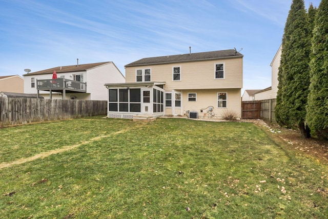 back of house with a yard, a fenced backyard, a sunroom, and central air condition unit