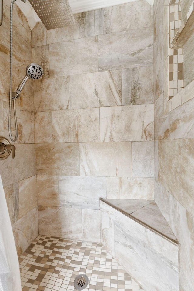 interior details featuring a tile shower