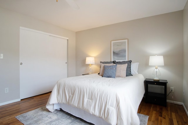 bedroom featuring a closet, baseboards, and wood finished floors