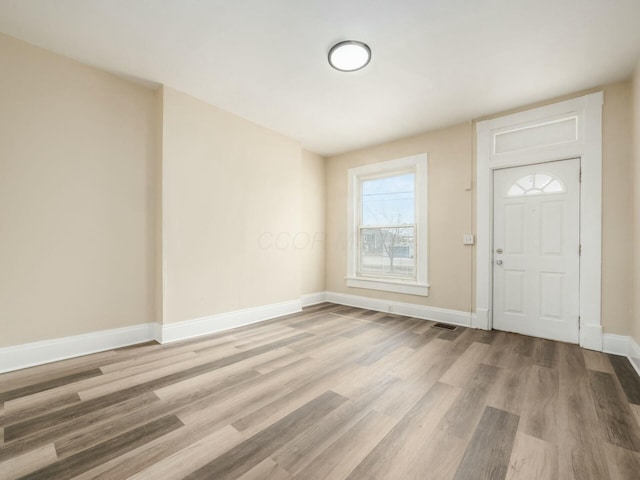 entrance foyer with baseboards, visible vents, and light wood-style floors